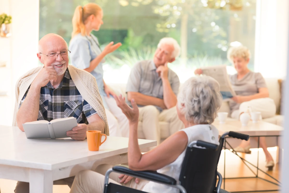 Residents reading and talking in a bright common room